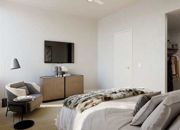 a bedroom with a bed and a television on the wall