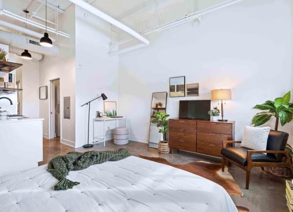 a bedroom with a bed and a rug on the floor