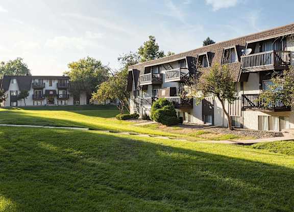 Exterior view of Trailgrove Apartments in Denver with classic architecture and well-maintained landscaping.