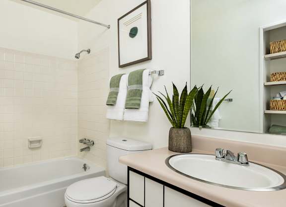 Classic bathroom inside Trailgrove Apartments in Denver with full tub and shower.