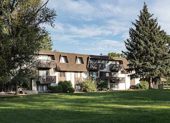 Wide view of apartment buildings and maintained green spaces at Willowstone Apartments in Denver CO 80231