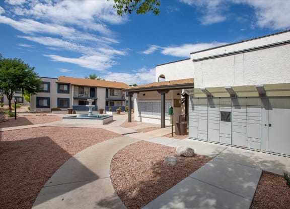 a courtyard with a fountain in front of an apartment building