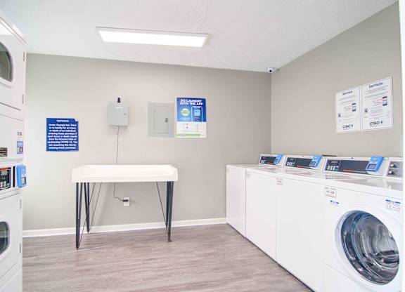 Clothes care center with washers and dryers at Place at Midway apartments in Douglasville near Lithia Springs, GA