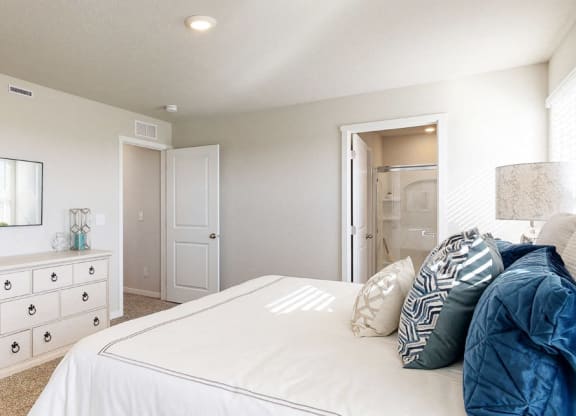 a bedroom with a bed and a dresser