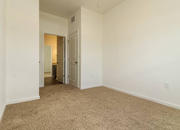 A room with carpeted floor and white walls.