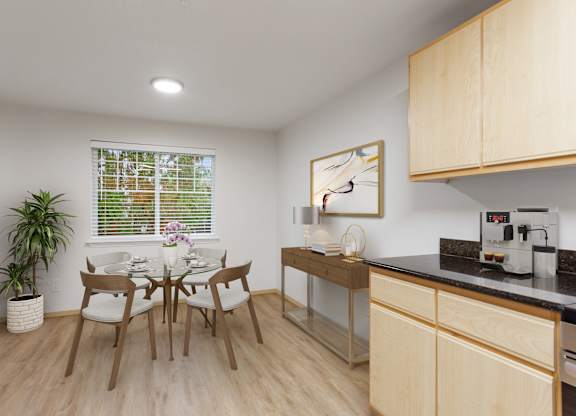 A kitchen with a table and chairs and a plant.