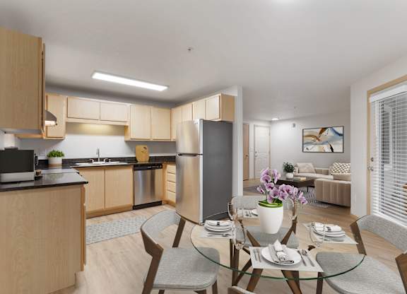 A modern kitchen with a dining table set for two.