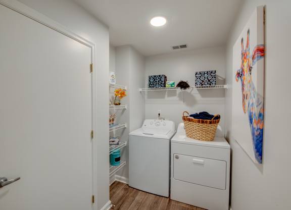 A small laundry room with a washer and dryer.