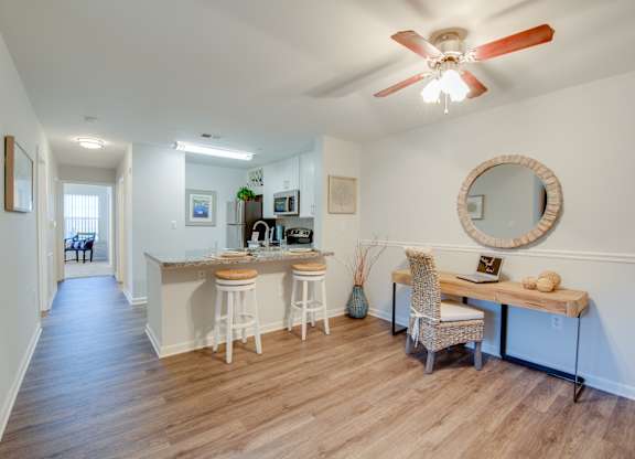 A kitchen with a bar and a chair.