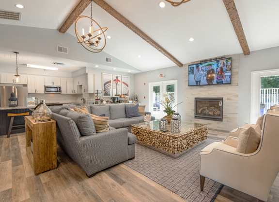 A modern living room with a grey couch and a wooden coffee table.