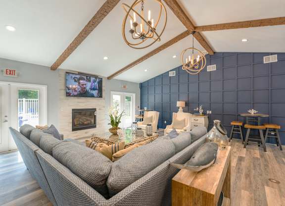 A modern living room with a grey sofa and a wooden coffee table.