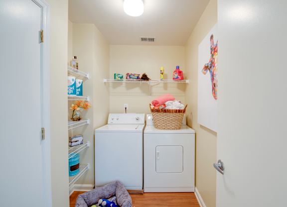 A small laundry room with a washer and dryer.