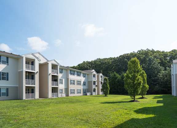 Apartment complex with a green lawn in front.