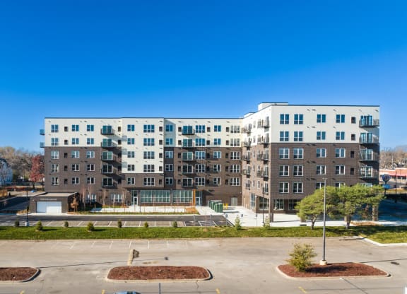 a large apartment building with a fountain in front of it