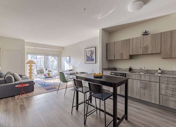 A modern kitchen with a dining table and chairs.