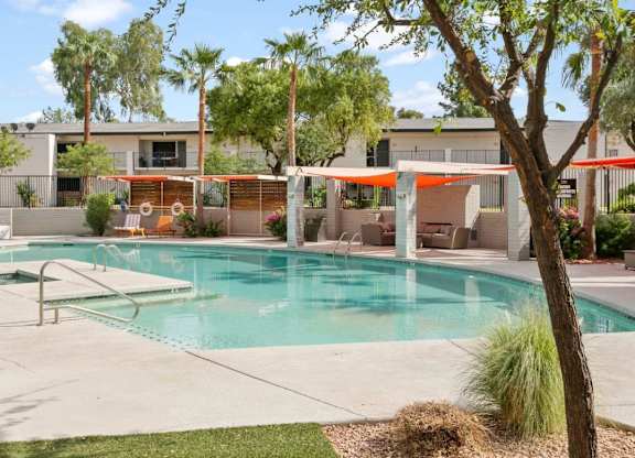 Resort-inspired pool with sun deck and lounge chairs at Sentry Tempe apartments in Tempe near Mesa, Arizona