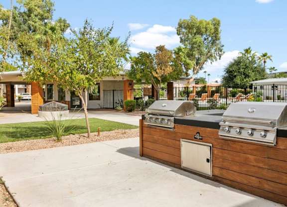 Outdoor picnic and BBQ stations with seating at Sentry Tempe apartments in Tempe near Mesa, Arizona