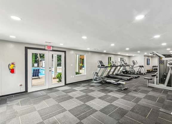 A gym with treadmills, weights and exercise machines.