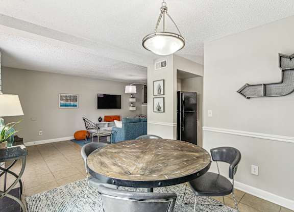 A dining room with a round table and chairs.