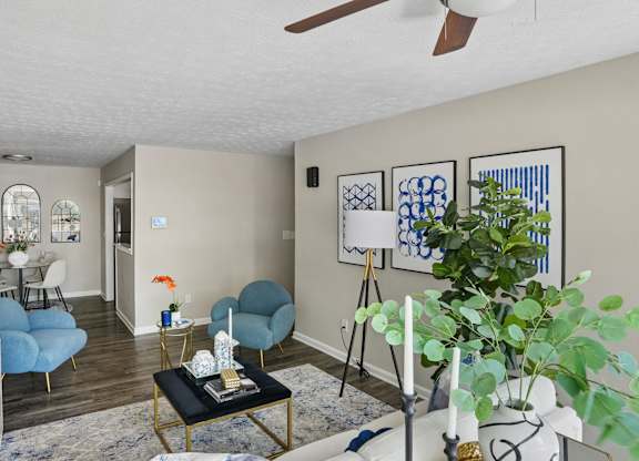 A living room with a blue chair and a black coffee table.