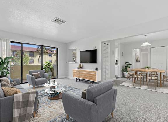 A living room with grey couches and a wooden entertainment center.