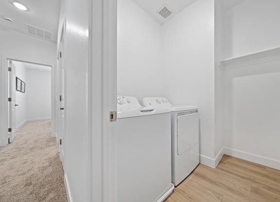 A laundry room with a washer and dryer.