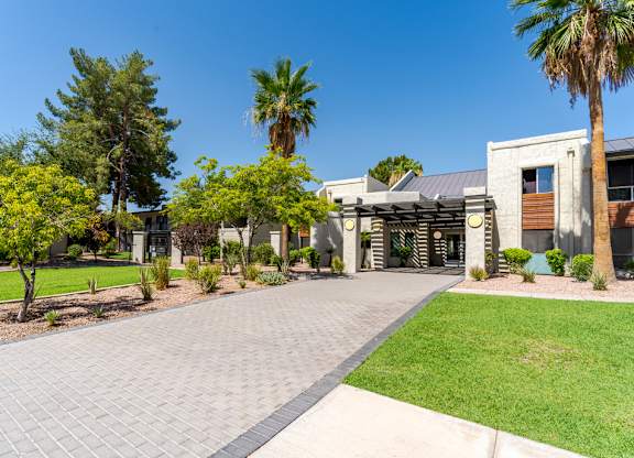 Landscaped entrance to Sono Tempe Apartments in Tempe, AZ with desert-inspired greenery and walkable community paths.