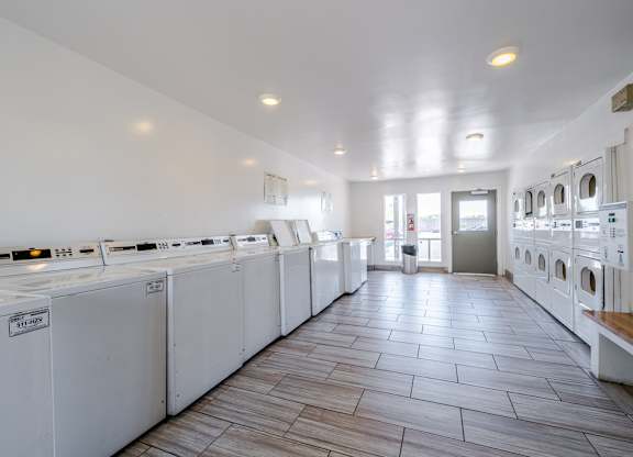 On-site laundry facilities at Sono Tempe Apartments in Tempe, AZ with multiple washers and dryers for resident convenience.