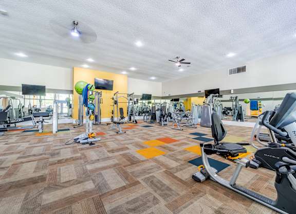 Fully equipped fitness center at Sono Tempe Apartments in Tempe, Arizona with cardio machines and strength equipment.