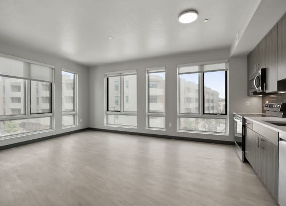an empty living room with a large window