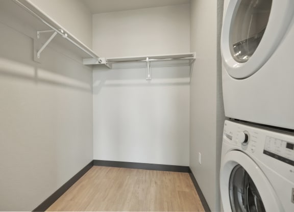 an empty laundry room with a washer and dryer