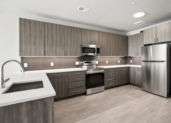 a kitchen with wooden cabinets and stainless steel appliances