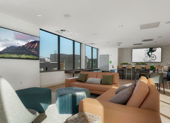 a living room with couches and chairs and a large screen tv on the wall