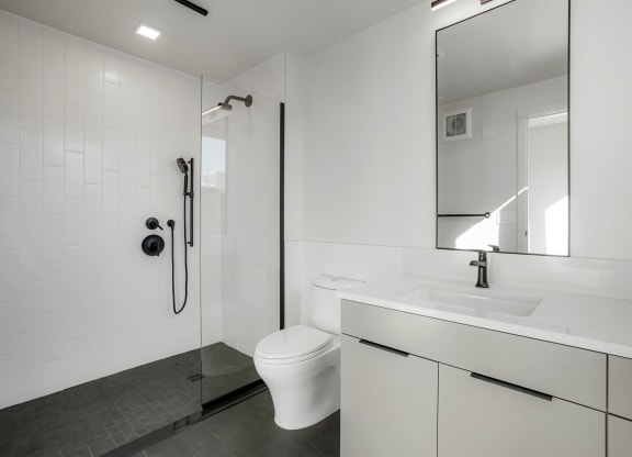 a bathroom with a toilet sink and shower