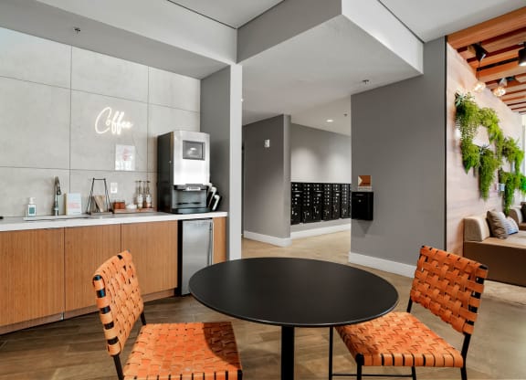 a dining area with a round table and two chairs