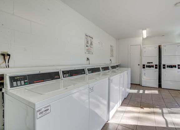 Laundry room with washers and dryers at Square One Apartments in Gainesville FL