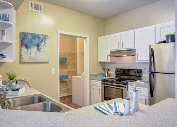 Modern kitchen with stainless steel appliances at Grande Club apartments in Duluth, GA 30096, near Lawrenceville.