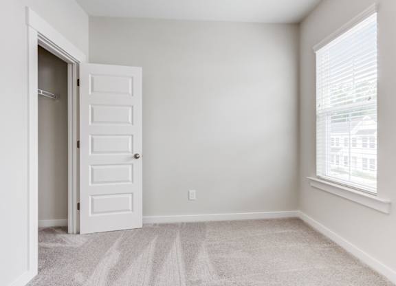 Dog Friendly Townhomes in Park Circle SC - Sumner Village - Well Lit Bedroom with Carpet Flooring, Large Closet, and a Window