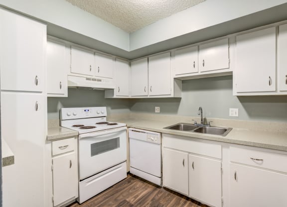 The Commons Apartments in Tampa Florida photo of a kitchen with white cabinets and white appliances