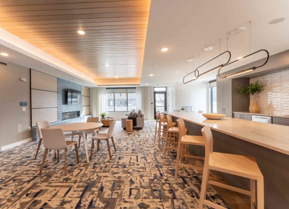 a dining room with tables and chairs and a kitchen