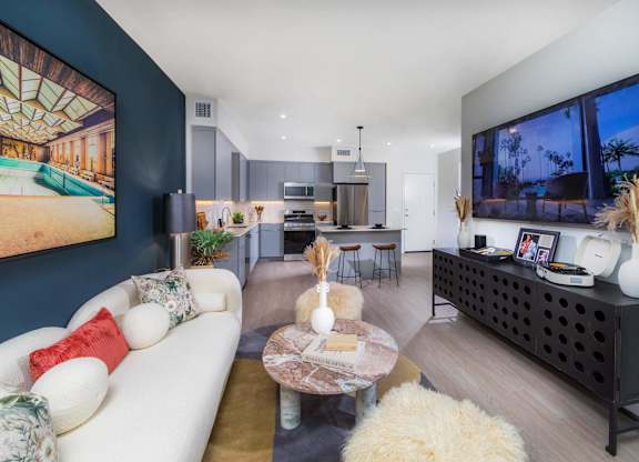 A modern living room with a white sofa and a coffee table.