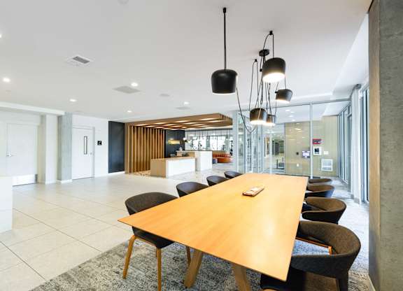 A conference room with a long table and chairs.