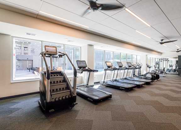 A gym with treadmills and elliptical machines.
