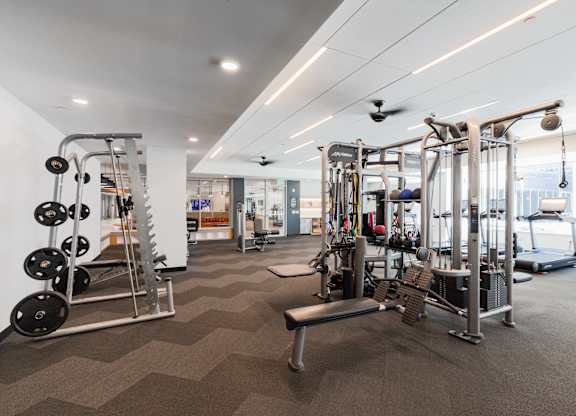 A well-equipped gym with a variety of machines and weightlifting equipment.
