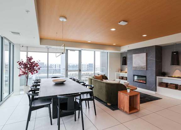 A modern dining room with a wooden table and chairs.