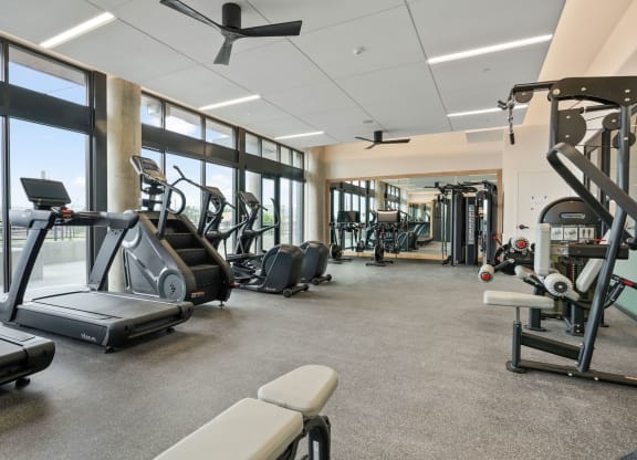 Studios In Wheat Ridge, CO - The Parallel - Fitness Center Equipped With Cardio Machines, Strength Training Machines, Full Body Mirror, And Floor To Ceiling Windows