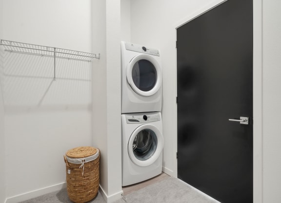 walk in closet with full size washer and dryer