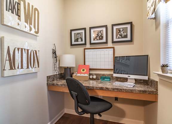 a home office with a desk and computer