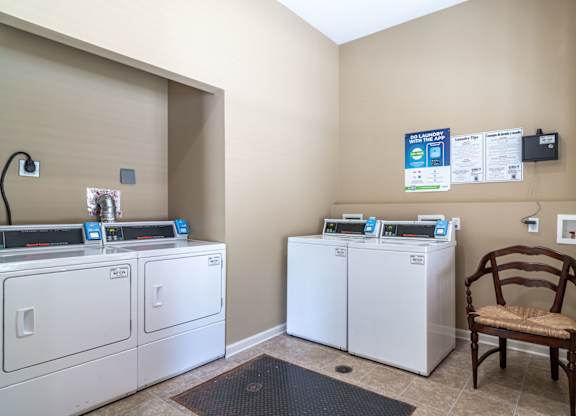 Pet-Friendly Apartments in Opelika, AL – The Crossings of Opelika - a laundry room with washers and dryers