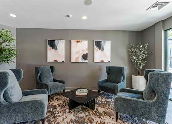A living room with grey chairs and a coffee table.